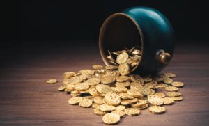 bowl with gold coins spilling out of it