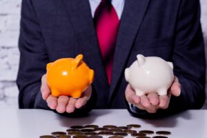 a man in a suit holding a pumpkin and a stack of coins