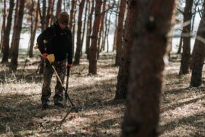 a person with a shovel in the woods