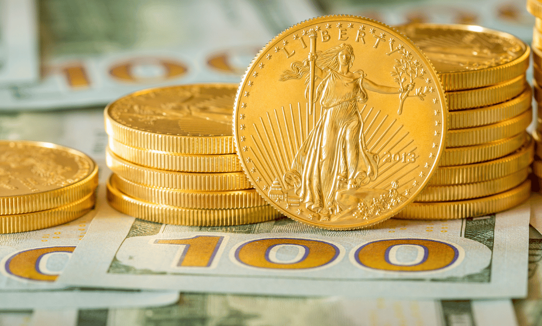 Gold American Eagles stacked on 100 dollar bills.