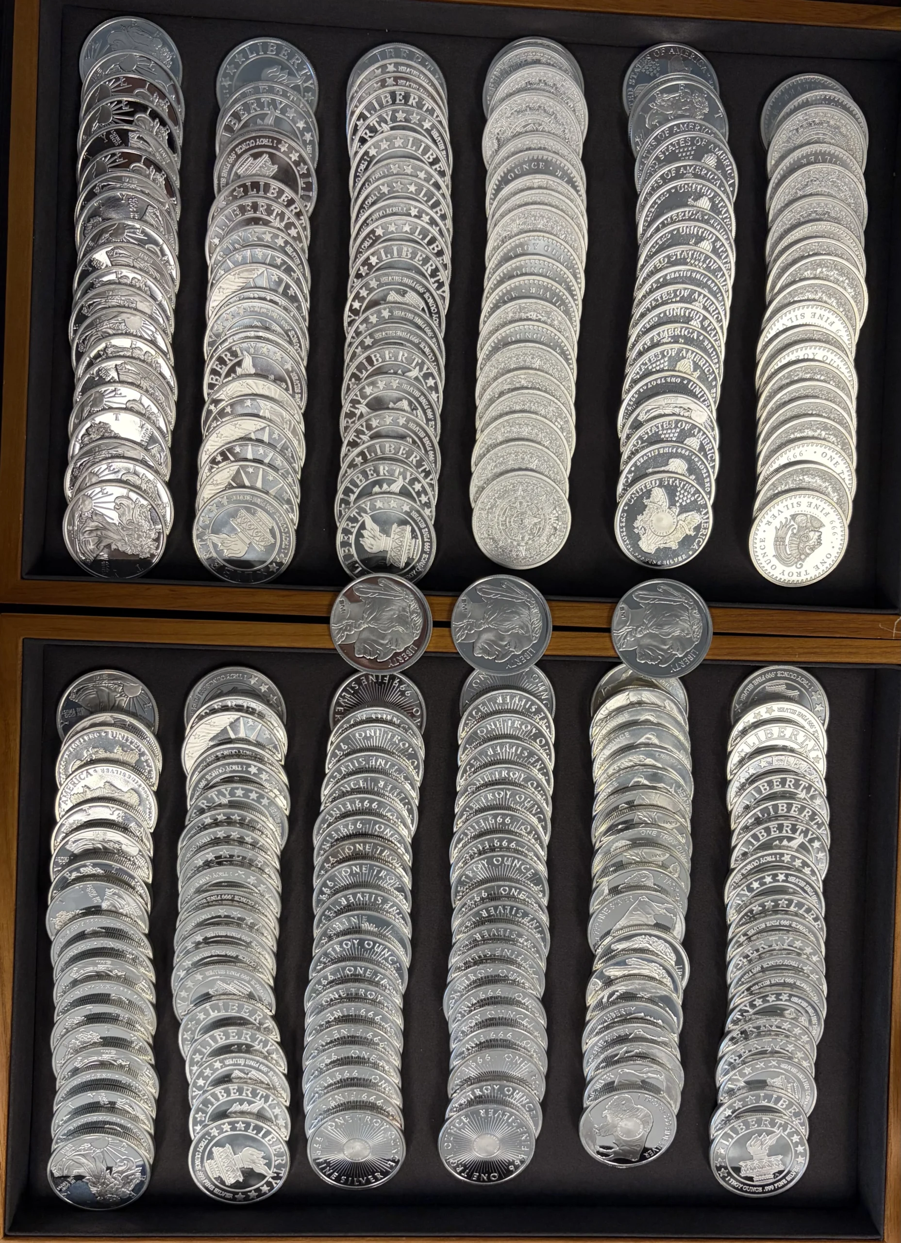 Rows of shiny silver coins arranged in vertical industrial | Metals Edge Rows of shiny silver coins arranged in vertical industrial