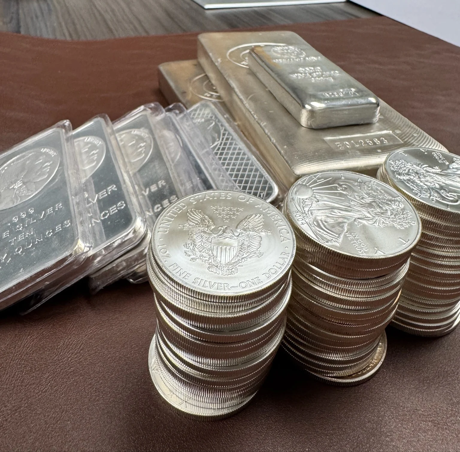Stacks of silver bars and coin stacks | Metals Edge Stacks of silver bars and coin stacks